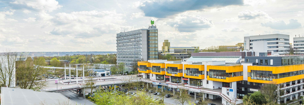The North Campus with cafeteria and math tower and cloudy sky in the background